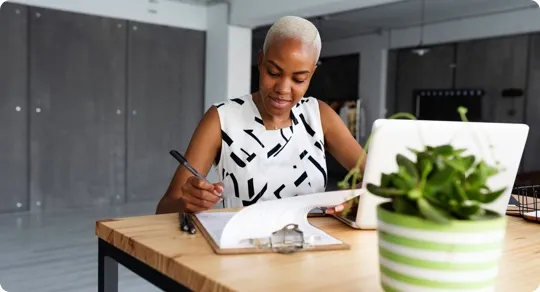 Woman making a list on a clipboard.