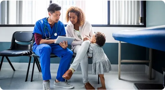 Mom and daughter consulting with a physician at a child clinic.