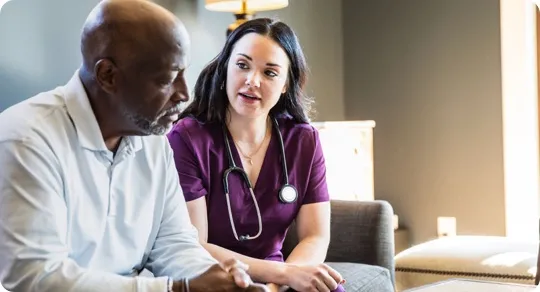 Nurse speaking with her patient.