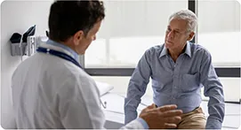 Physician consulting with a patient about treatment options during a visit.