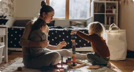 Daycare worker playing with children.