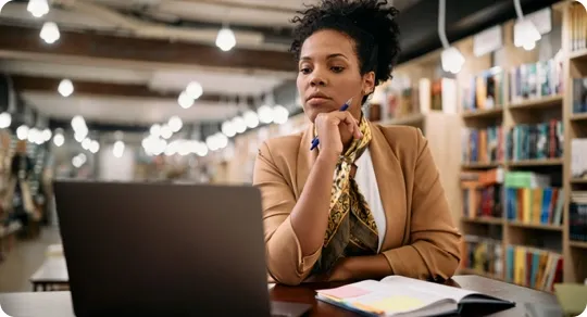 Woman studying at a library.