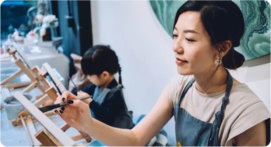 Mother painting with her daughter.