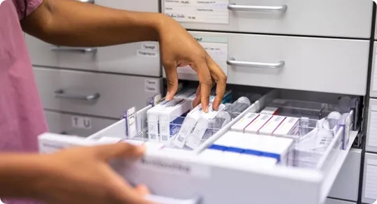 Pharmacist organizing the medicines in the drawer.