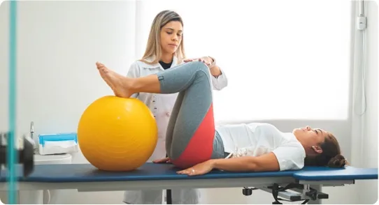 Doctor guiding her patient through physical therapy.