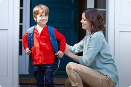 Mother sending her son to school.