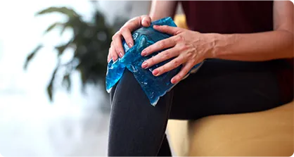 Woman massaging the pain on her knee.